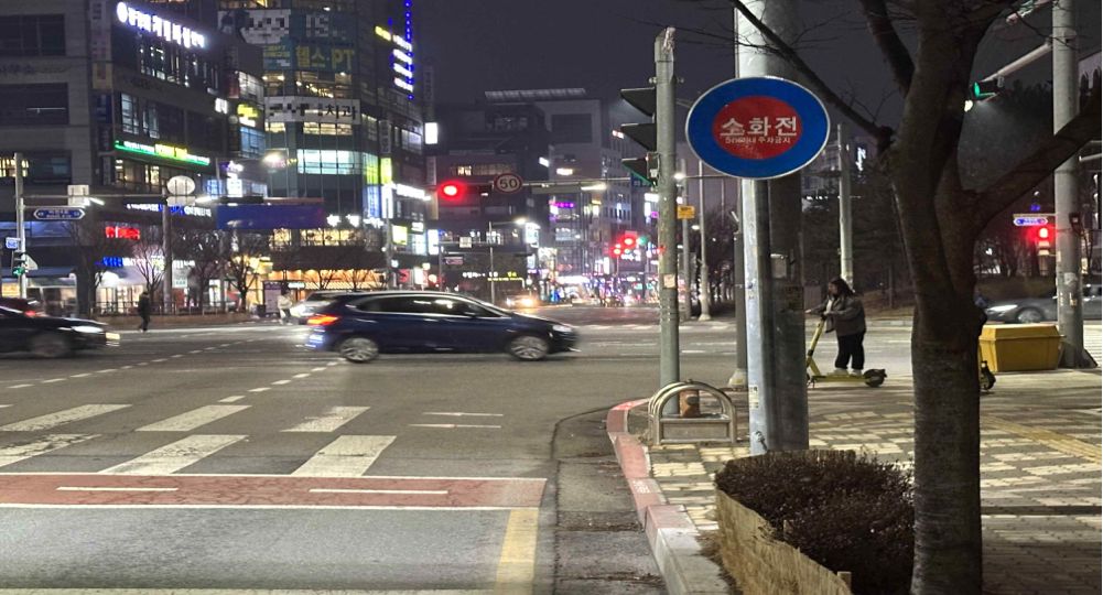 Crossroads intersection · Road with three lanes in each direction · Person riding a personal mobility device on the sidewalk