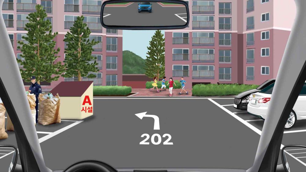Person sorting recyclables on the left · White lights on the white car on the right · Car visible in the interior rear-view mirror
