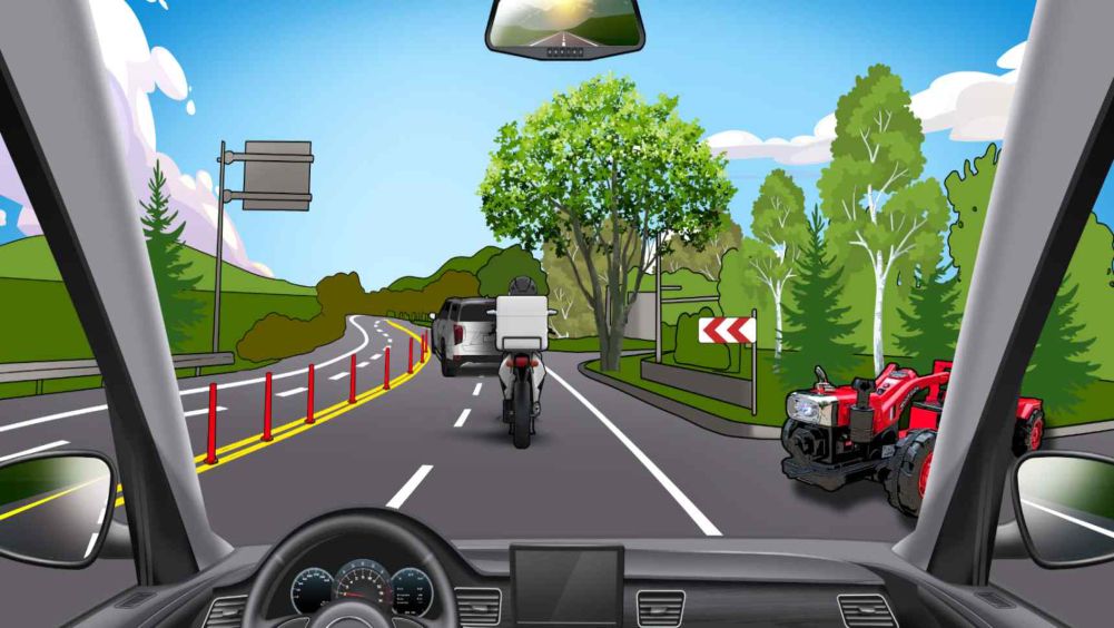 An uphill road curving to the left · A motorcycle riding ahead · A farm machine about to enter the road