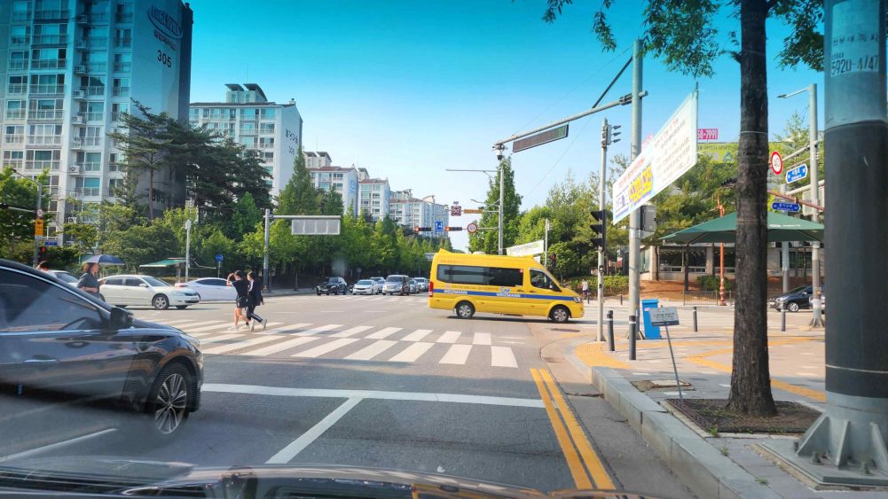 Vehicle traffic light ahead is red · A pedestrian is crossing the crosswalk · Four-way intersection · Three-color right-turn light; no auxiliary vehicle light